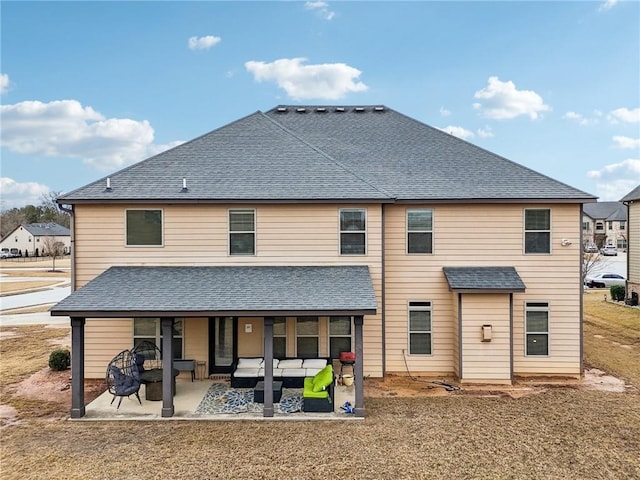 back of house with roof with shingles, a patio, a lawn, and an outdoor hangout area