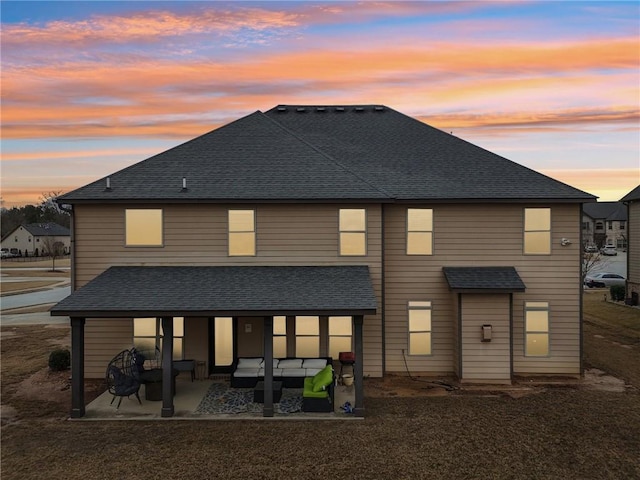 back of property featuring a shingled roof, an outdoor hangout area, and a patio