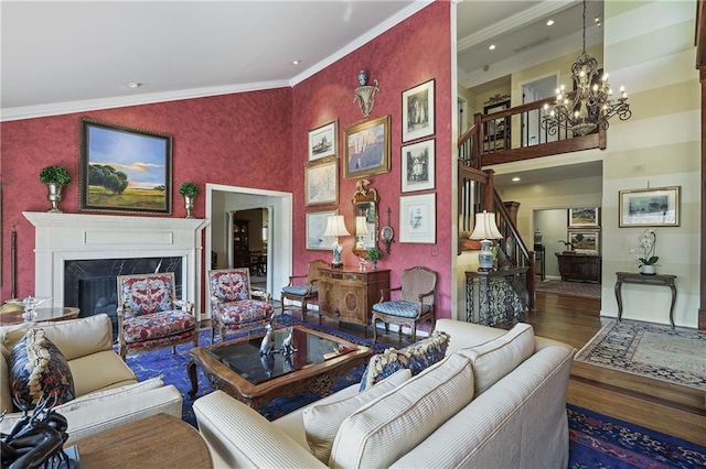 living area with dark wood-style floors, stairway, a fireplace, and crown molding