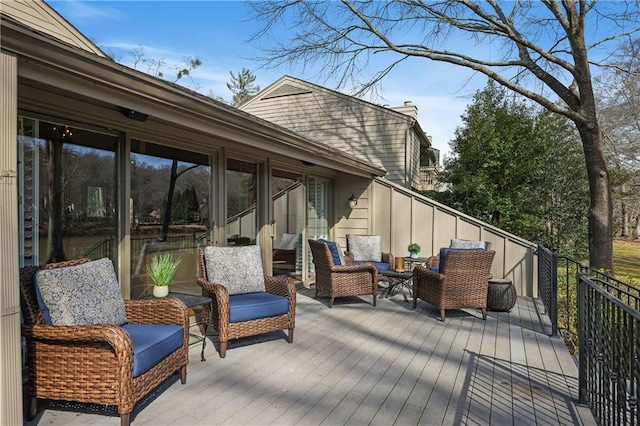 wooden terrace featuring an outdoor living space