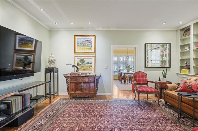 sitting room featuring recessed lighting, wood finished floors, and crown molding