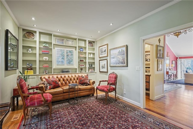 living room with ornamental molding, recessed lighting, wood finished floors, and baseboards