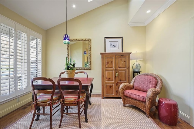 dining space with lofted ceiling, recessed lighting, light wood-style flooring, and baseboards