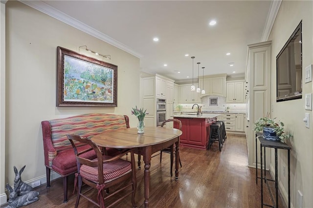 dining area with dark wood-type flooring, recessed lighting, and crown molding