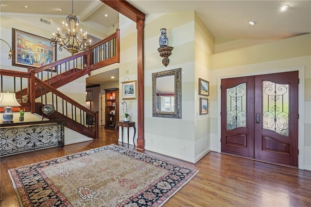 entryway with visible vents, stairway, wood finished floors, french doors, and beam ceiling