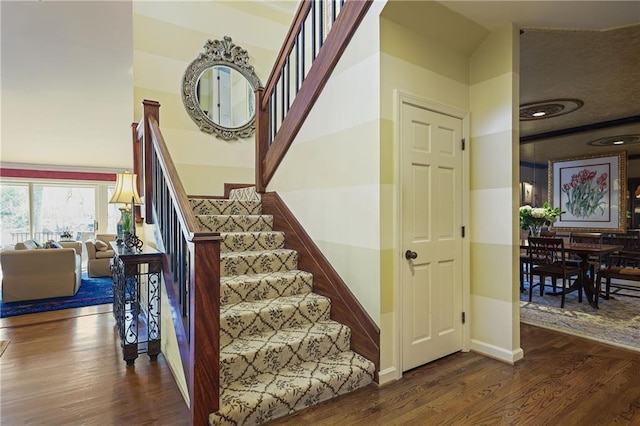 staircase with wood finished floors