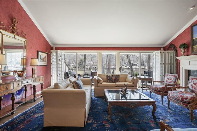 living room with dark wood-type flooring, lofted ceiling, a fireplace, and crown molding