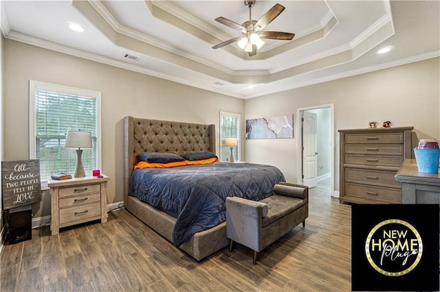 bedroom featuring visible vents, a raised ceiling, and wood finished floors