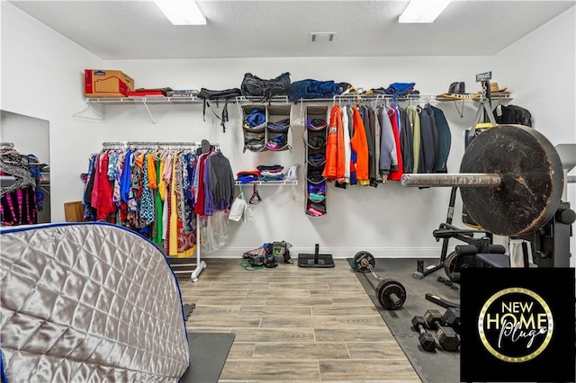 walk in closet with wood finished floors and visible vents