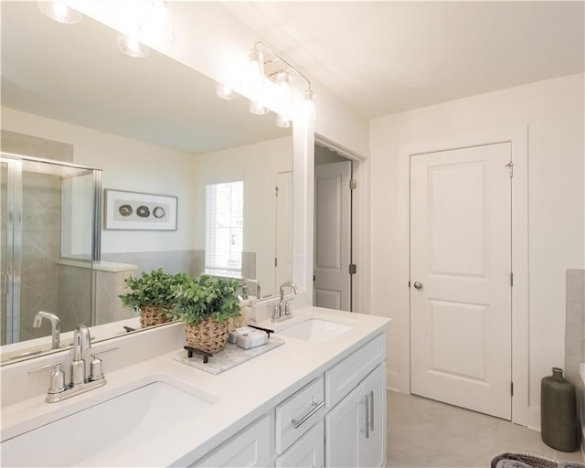 bathroom with vanity and a shower with door