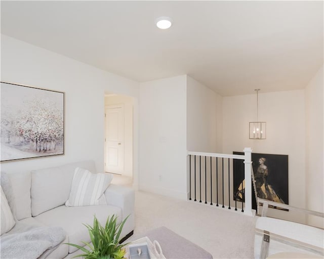 living room featuring light carpet and a chandelier