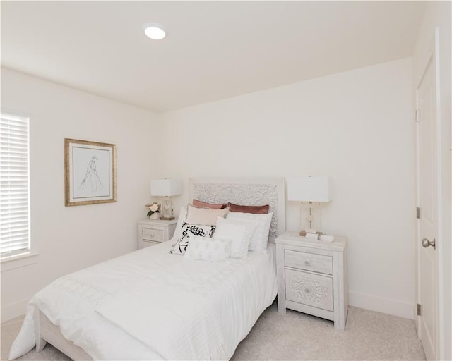 bedroom featuring light carpet