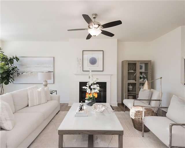 living room with light wood-type flooring and ceiling fan