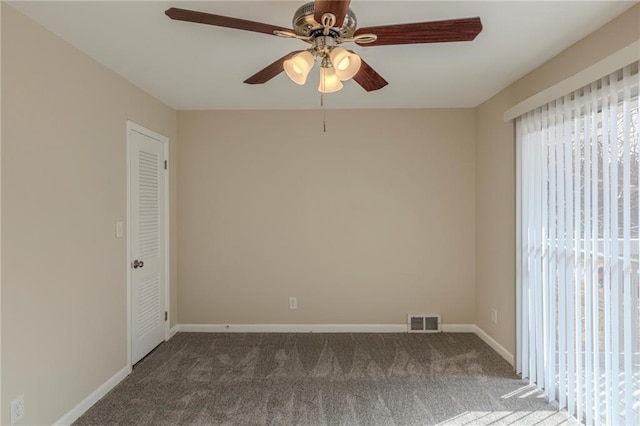 carpeted spare room with ceiling fan