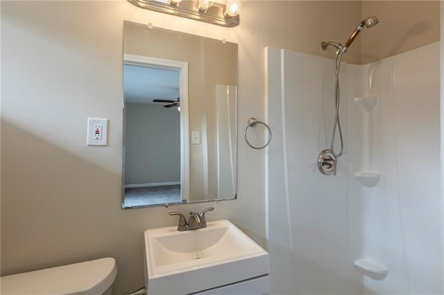 bathroom featuring vanity, toilet, and a shower