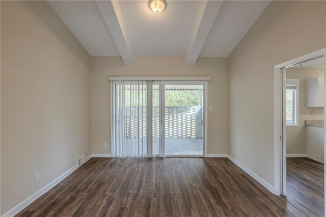 spare room featuring dark hardwood / wood-style floors and lofted ceiling with beams