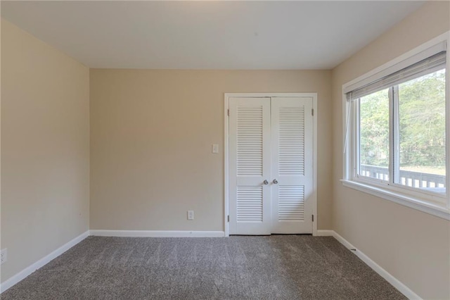 unfurnished bedroom with a closet and carpet