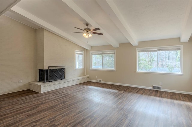 unfurnished living room with ceiling fan, a fireplace, dark hardwood / wood-style flooring, and vaulted ceiling with beams