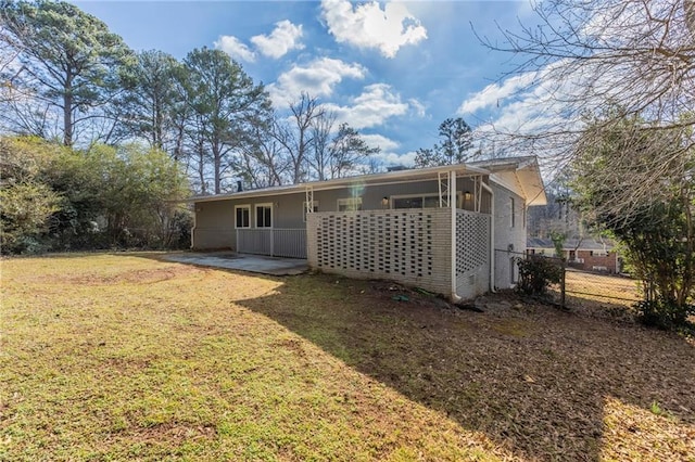 back of house featuring a patio and a yard