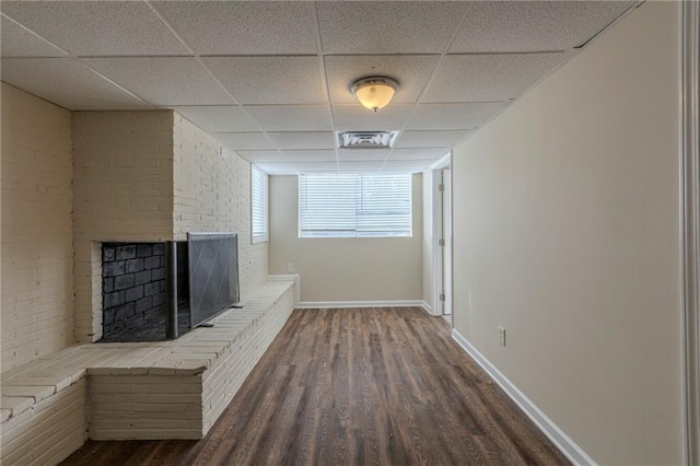 hallway with a paneled ceiling and dark hardwood / wood-style flooring