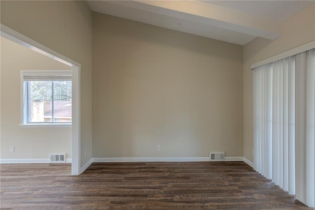 unfurnished room featuring dark wood-type flooring