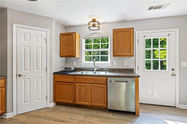 5706 Forest Pl, Acworth, GA 30102 - kitchen featuring dishwasher, dark countertops, brown cabinets, and light wood-style flooring