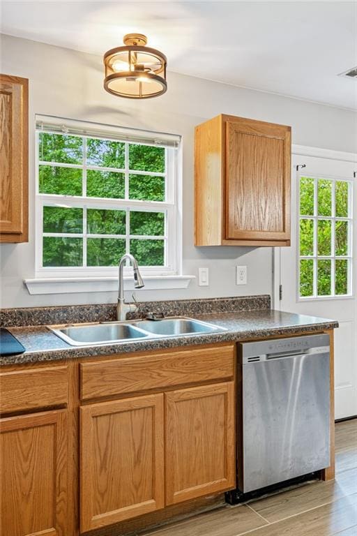 5706 Forest Pl, Acworth, GA 30102 - kitchen featuring stainless steel dishwasher, dark countertops, and light wood finished floors