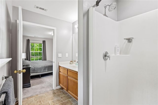 5706 Forest Pl, Acworth, GA 30102 - bathroom featuring vanity, a shower, stone finish floors, and ensuite bath