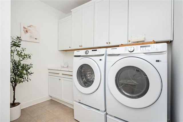 laundry room with cabinets, light tile patterned floors, and independent washer and dryer