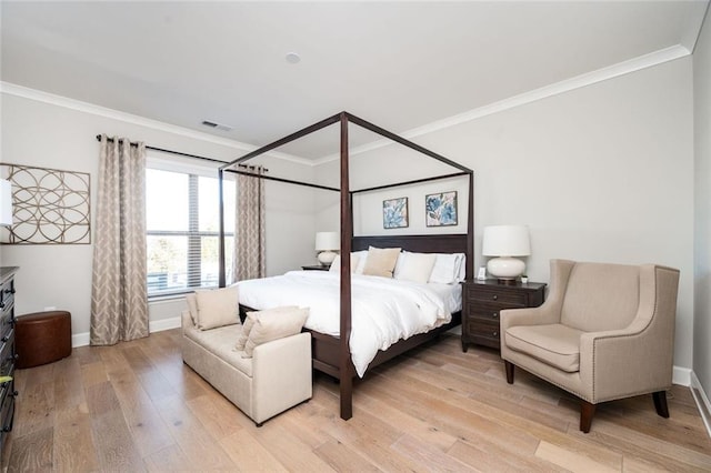 bedroom with crown molding and light hardwood / wood-style flooring