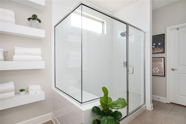 bathroom with tile patterned floors and walk in shower