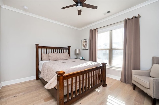 bedroom with multiple windows, ceiling fan, crown molding, and light hardwood / wood-style flooring