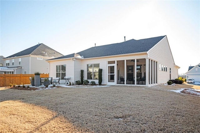 rear view of house with a patio area and a sunroom