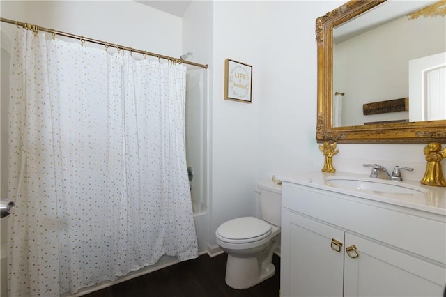 bathroom featuring toilet, shower / bath combo, wood finished floors, and vanity