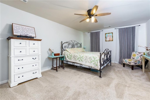 bedroom featuring light carpet, visible vents, and baseboards