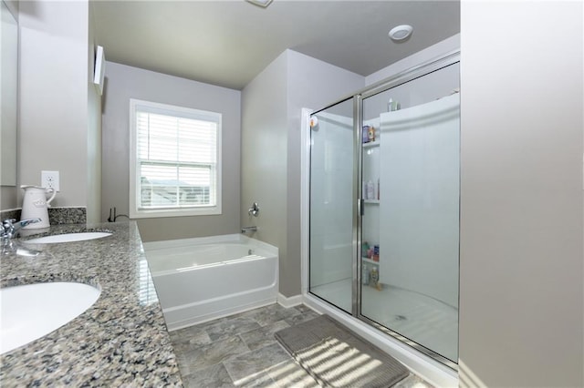 full bathroom featuring a bath, a shower stall, and a sink