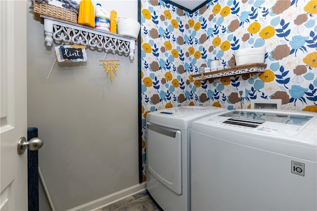 clothes washing area with laundry area, baseboards, washing machine and clothes dryer, and wallpapered walls