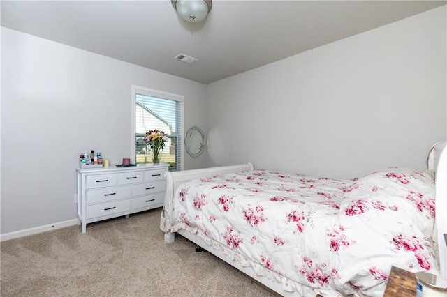 bedroom featuring light colored carpet, visible vents, and baseboards