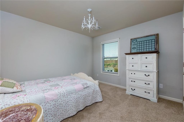 bedroom with light colored carpet, baseboards, and an inviting chandelier