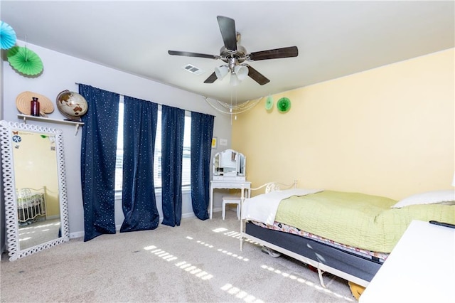 carpeted bedroom with ceiling fan and visible vents