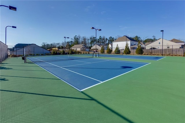 view of sport court featuring fence