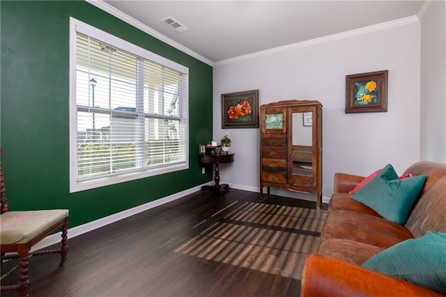 living area featuring ornamental molding, visible vents, baseboards, and wood finished floors