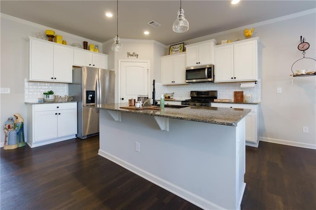 kitchen featuring visible vents, stainless steel appliances, crown molding, and dark stone counters