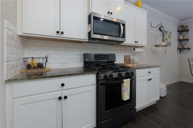 kitchen featuring tasteful backsplash, stainless steel microwave, ornamental molding, black range with gas cooktop, and dark stone countertops