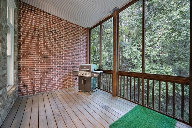 unfurnished sunroom with lofted ceiling