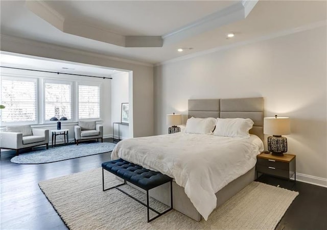 bedroom featuring a raised ceiling, crown molding, and dark hardwood / wood-style flooring