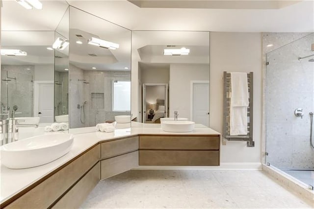 bathroom featuring vanity and a shower with shower door