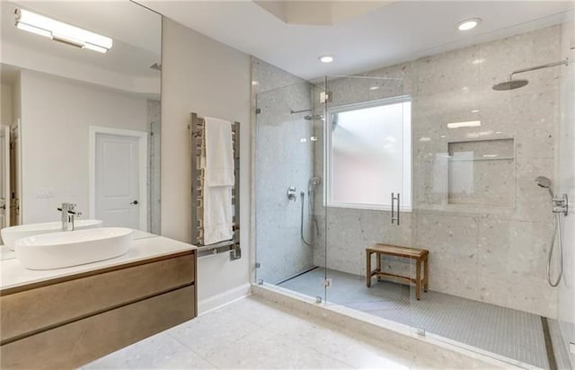 bathroom featuring tile patterned floors, vanity, and a shower with shower door