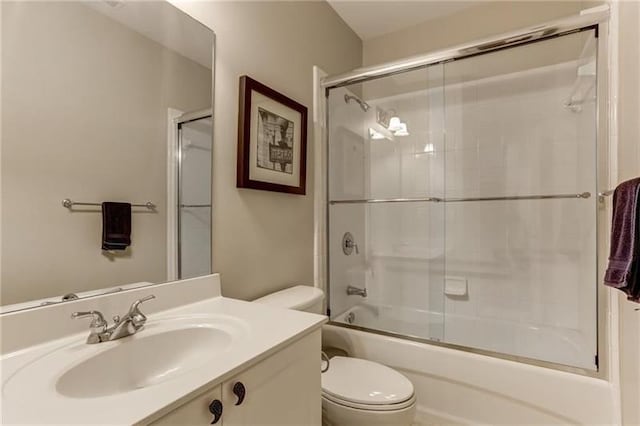 full bathroom with sink, enclosed tub / shower combo, and toilet