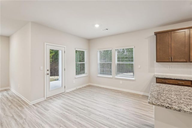 unfurnished dining area with light hardwood / wood-style floors